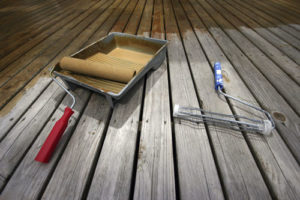 stain a deck with a roller and a brush