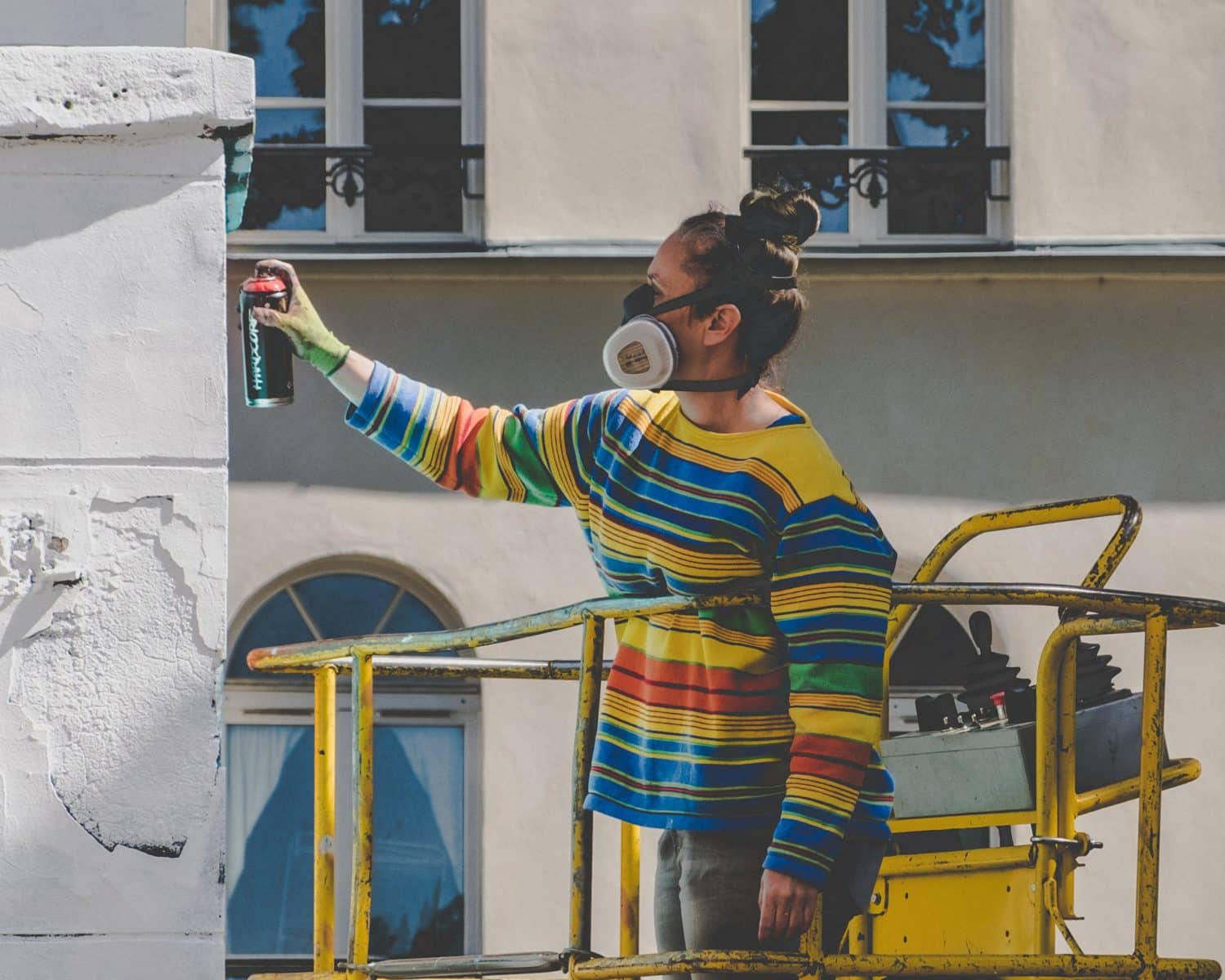 woman spraying paint Brad the Painter