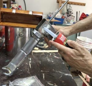 Painter showing How to use a caulk gun