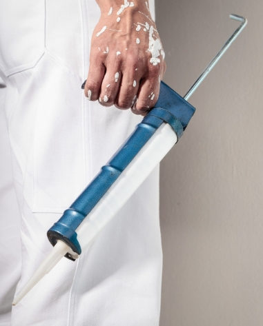 Painter holding a caulking gun