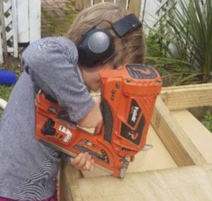 child uses a paslode framing nailer