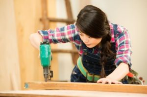 Woman working with a Quality Pin Nailer