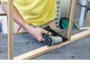 worker with a brad nail gun