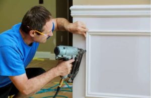 Brad nailer used by a working man Brad nailer for small trim: a finish nailer would split this