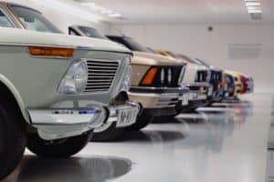 Classic autos in a garage with a painted floor white