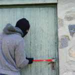 Thief Trying to Break into a Garage