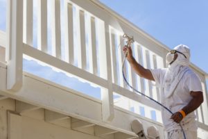 man spraying deck with pro paint sprayer man spraying deck with pro paint sprayer