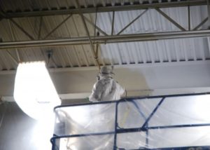 commercial paint sprayer on lift + man wearing suit