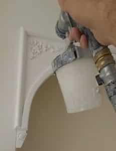 painter using HVLP paint sprayer